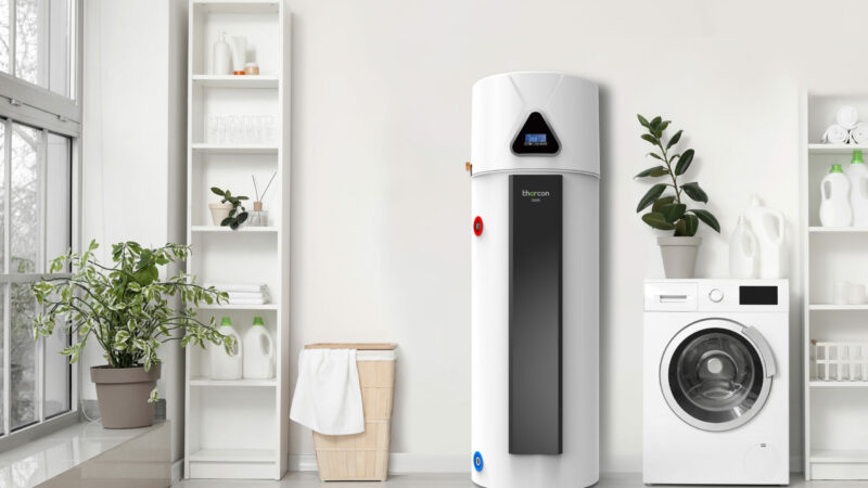 Boiler thermodynamique thercon - installation par KeepCool Hainaut Modern washing machine with basket and shelving units near white wall. Interior of home laundry room